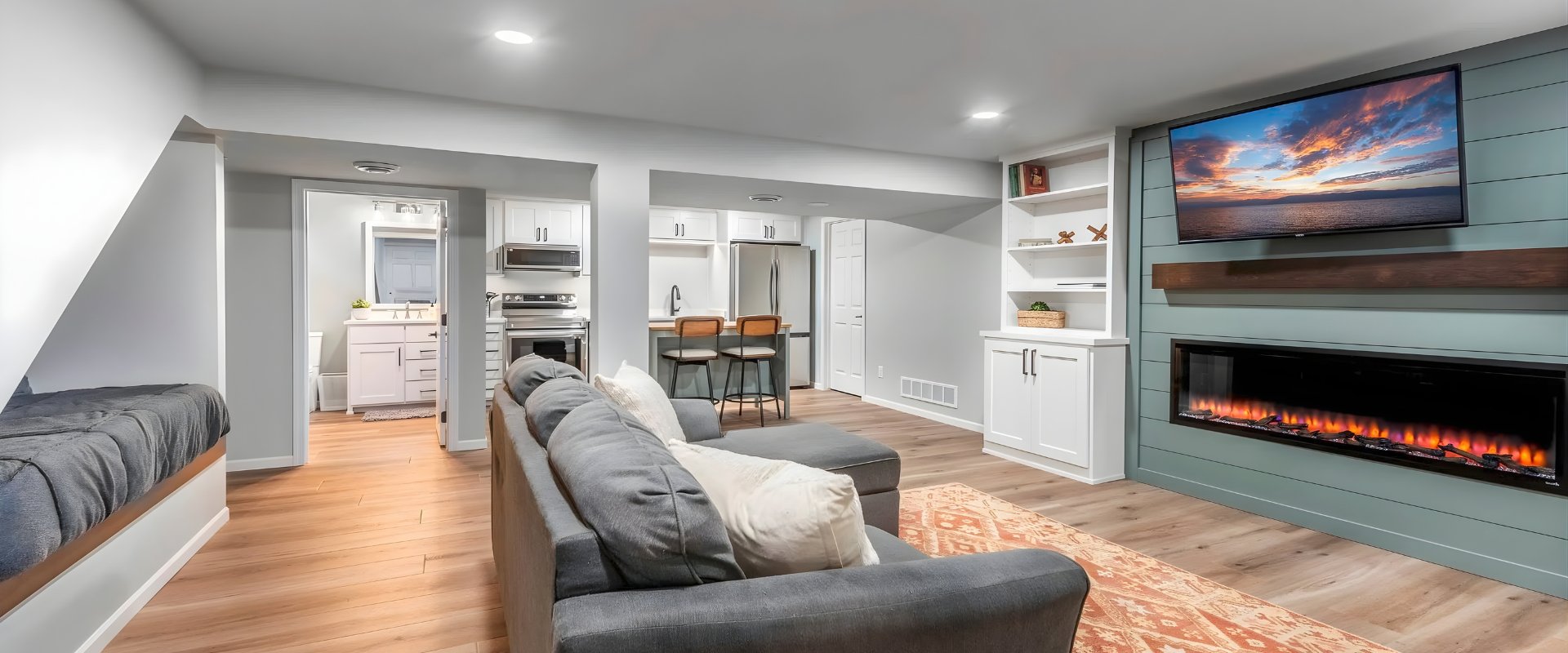 Finished basement with fireplace, built-in shelving, and kitchenette — Advanced Cabinetry Inc. Auburn Hills MI