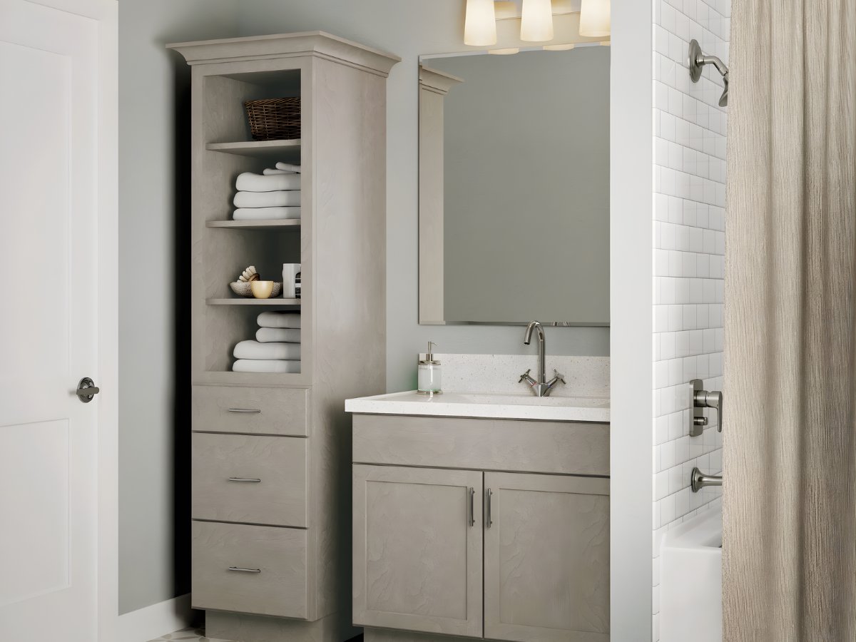 Gray bathroom vanity with open linen tower — Advanced Cabinetry Inc.