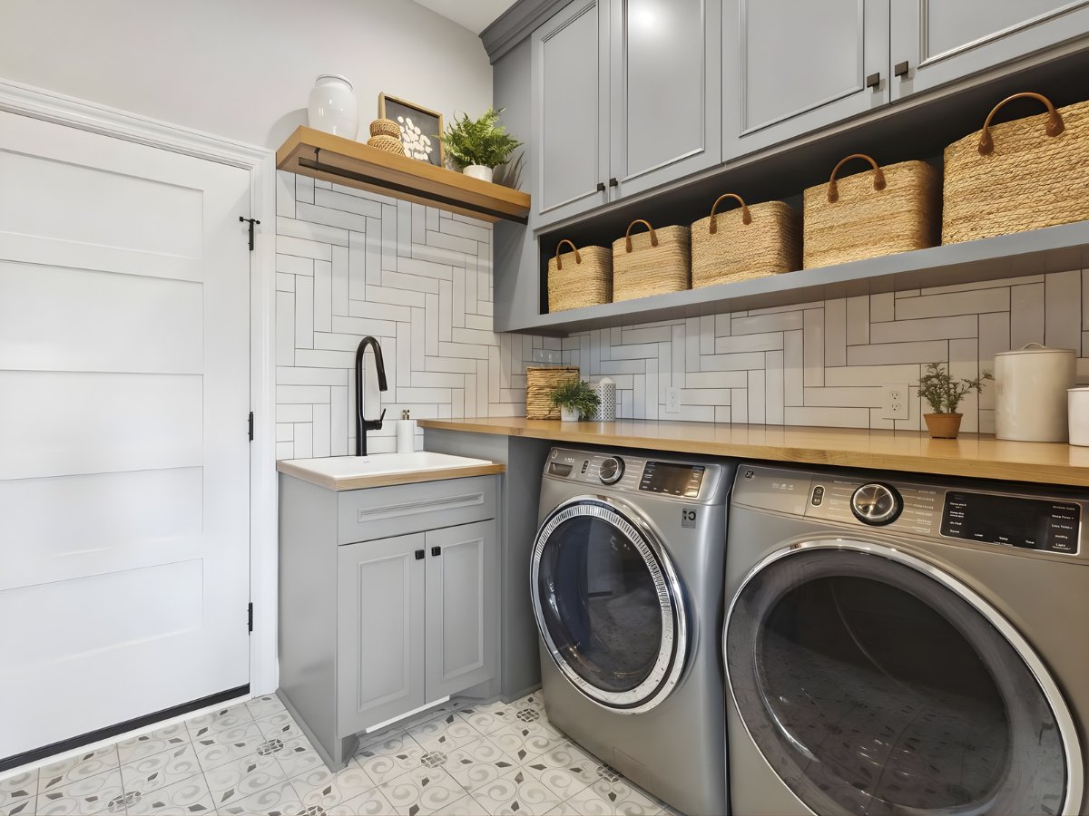 Gray laundry room cabinets with butcher block countertop — Advanced Cabinetry Inc.