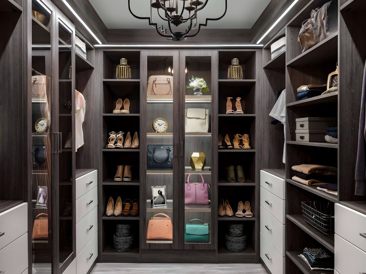 Luxury walk-in closet with glass doors and LED lighting — Advanced Cabinetry Inc.