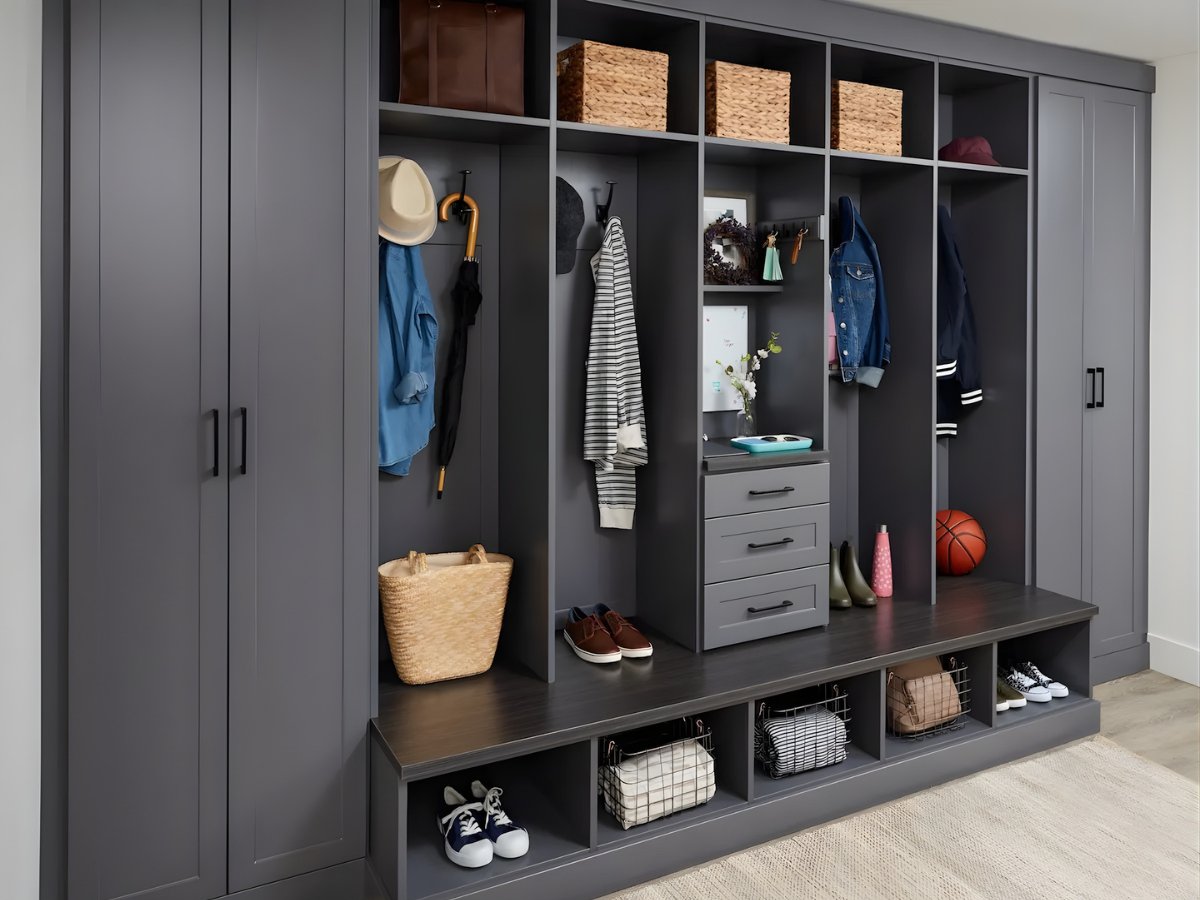 Dark gray mudroom entryway built-ins with hooks and bench — Advanced Cabinetry Inc.